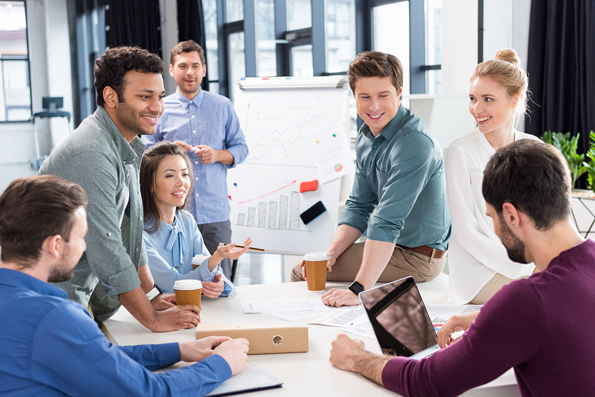 professional businesspeople discussing and brainstorming together on workplace in office, young